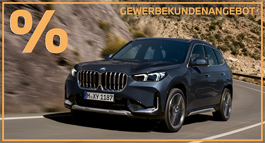 Hier ist die Beschreibung für das Bild des BMW X1:  Ein dunkelblauer BMW X1 fährt zügig auf einer kurvigen Bergstraße an einem felsigen Hang entlang direkt auf den Betrachter zu. Das Bild ist in einen markanten orangefarbenen Rahmen gefasst, der links oben ein großes Prozentzeichen und rechts oben den Schriftzug „GEWERBEKUNDENANGEBOT“ zeigt. Die präzise fokussierte Front des kompakten SUVs mit dem markanten Doppelkühlergrill und den hellen LED-Scheinwerfern sticht deutlich hervor, während der Asphalt und der Hintergrund in dynamischer Bewegungsunschärfe verschwimmen.